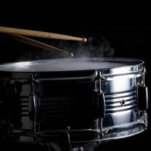 69349129-drum-sticks-hit-on-the-snare-drum-in-black-background-close-up-low-key